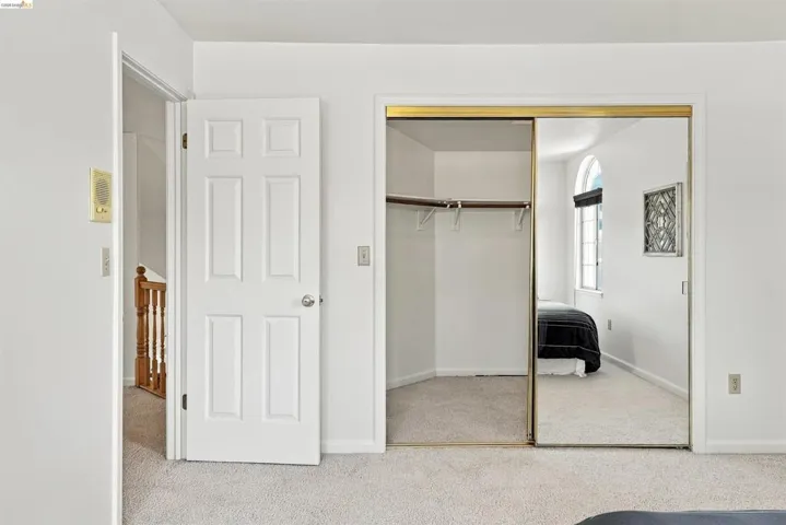 Mirrored sliding closet doors with gold-tone framing