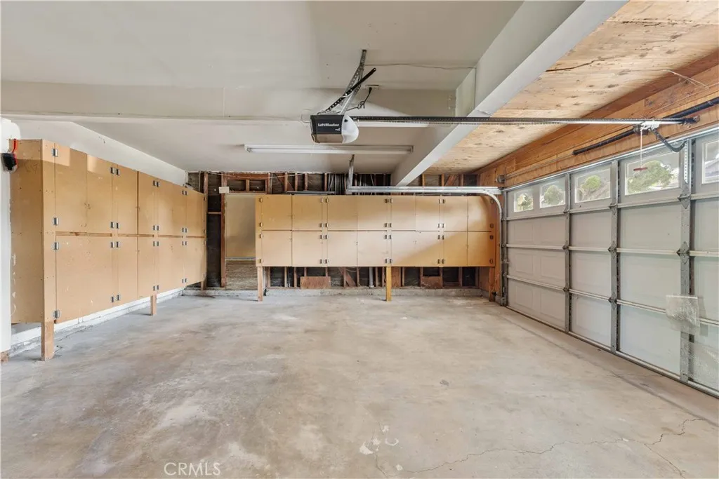 2-car garage with loads of storage cabinets.