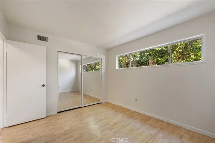 Bedroom #4 with a double-door mirrored wardrobe closet.