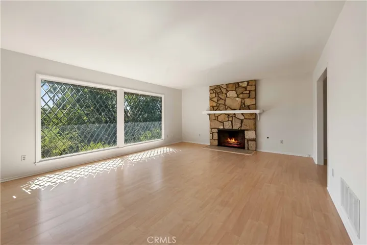 Large living room with a floor to ceiling fireplace.