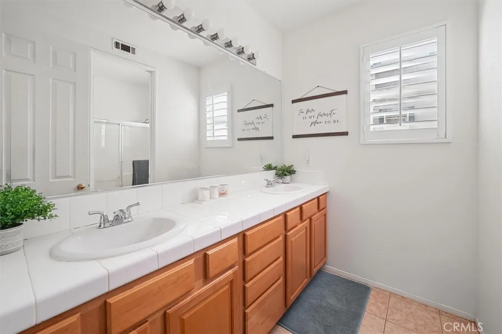 Secondary Bathroom with Dual Sinks & Separate Shower/Toilet Area