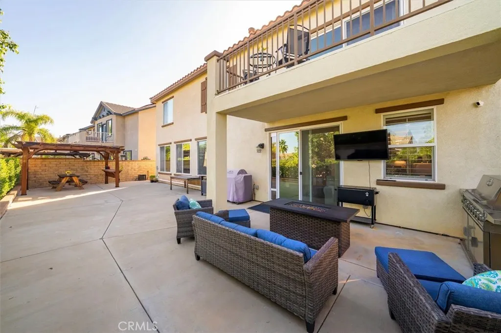 Low-maintenance yard with a covered patio and A/C units thoughtfully positioned along the side of the home for quieter entertaining.