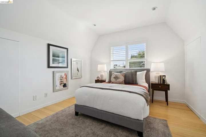 Recessed lighting, sloped ceiling, plantation shutters, light wood-finish flooring, and built-in wall access panel