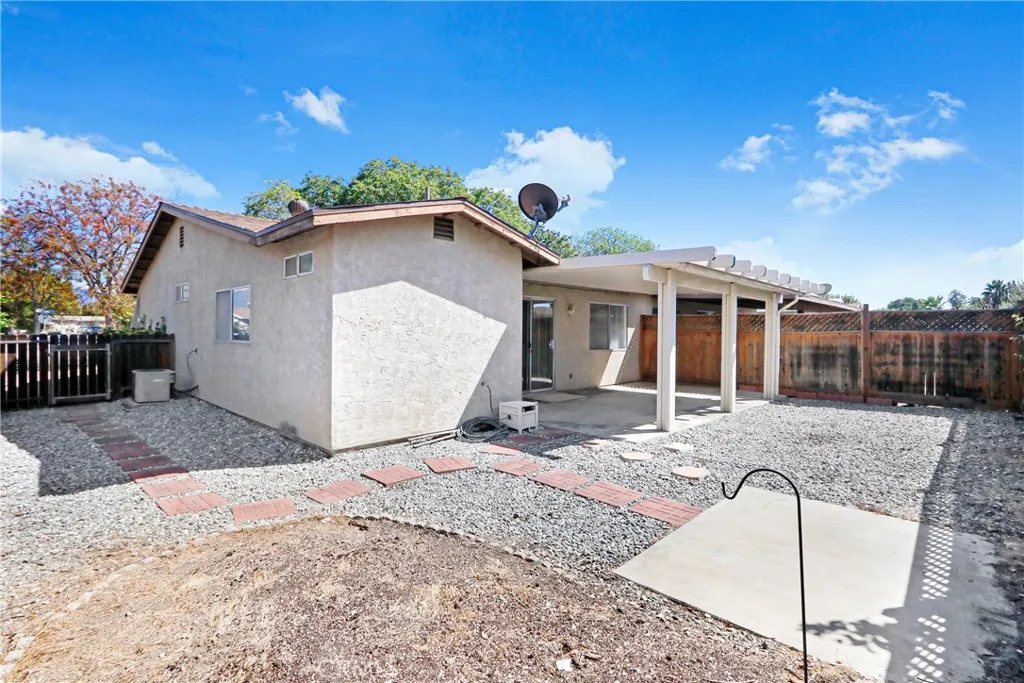 Your spacious gated low maintenance backyard with covered patio.