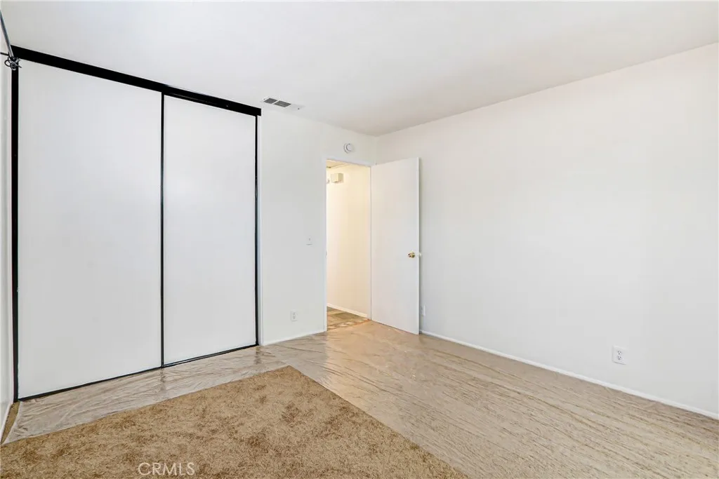 Spacious closet with sliding doors.