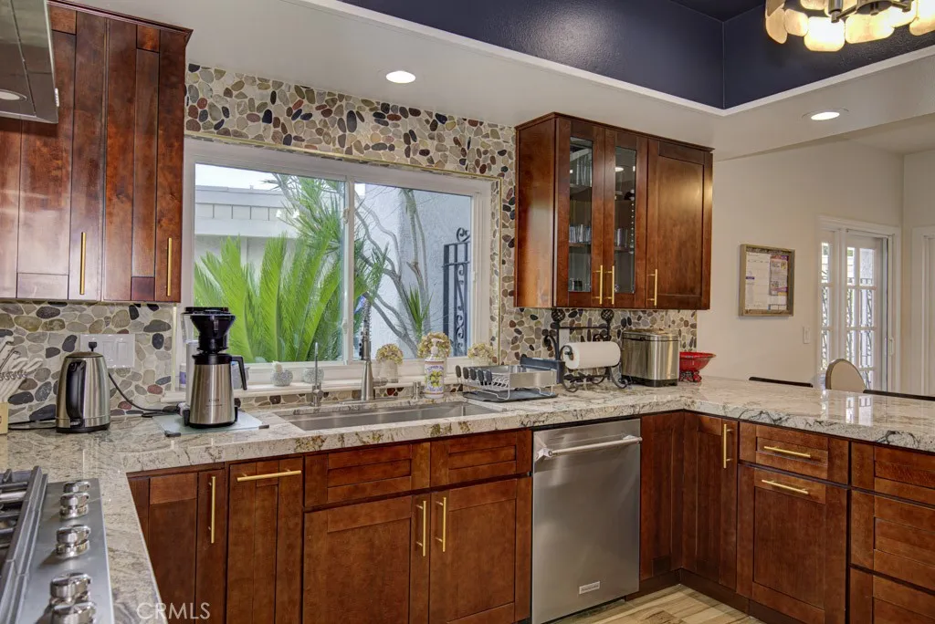 Gorgeous kitchen was recently remodeled and boasts new wood cabinetry with beautiful granite countertops complimented by a decorative stone backsplash. Gorgeous kitchen was recently remodeled and boasts new wood cabinetry with beautiful granite countertops complimented by a decorative stone backsplash.