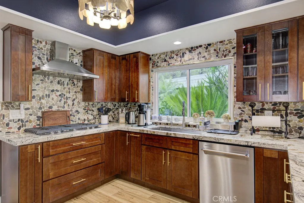 Another view of the remodeled kitchen. Upgrades include stainless steel KitchenAid appliances (including a gas cooktop), large farmhouse sink, soft-close cabinet doors and drawers, multiple pots and pans drawers, trash/recycling drawer, spice drawer and multiple lazy susans. Another view of the remodeled kitchen. Upgrades include stainless steel KitchenAid appliances (including a gas cooktop), large farmhouse sink, soft-close cabinet doors and drawers, multiple pots and pans drawers, trash/recycling drawer, spice drawer and multiple lazy susans.