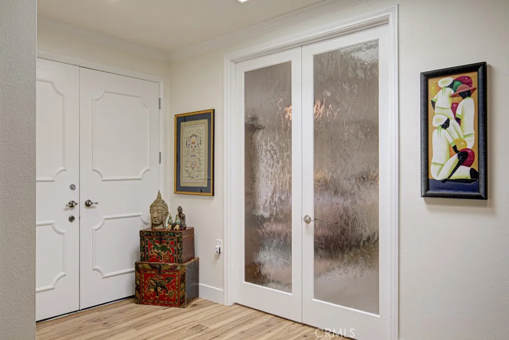 Entry to the primary bedroom suite at right. Front door to the residence at left. Entry to the primary bedroom suite at right. Front door to the residence at left.
