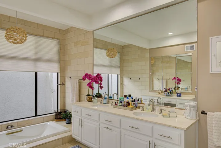 Primary bathroom has dual sinks and a separate tub.