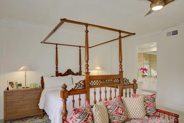 Another view of the primary bedroom suite. Entry to the primary bathroom at right.