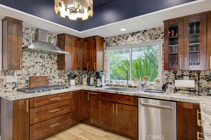 Another view of the remodeled kitchen. Upgrades include stainless steel KitchenAid appliances (including a gas cooktop), large farmhouse sink, soft-close cabinet doors and drawers, multiple pots and pans drawers, trash/recycling drawer, spice drawer and multiple lazy susans.