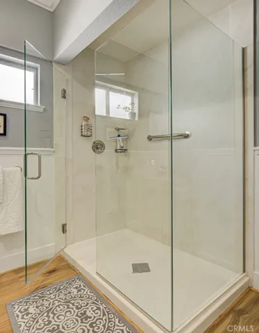 Guest bathroom has an oversized stall shower.
