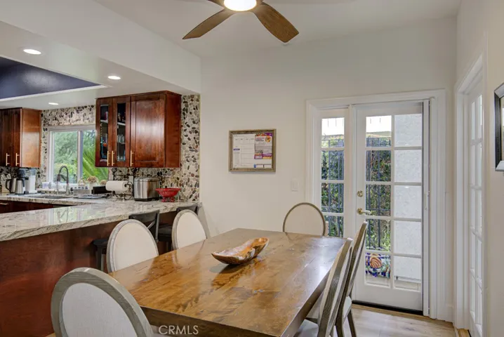 Another view of the kitchen's breakfast nook. There is also a breakfast bar at left.