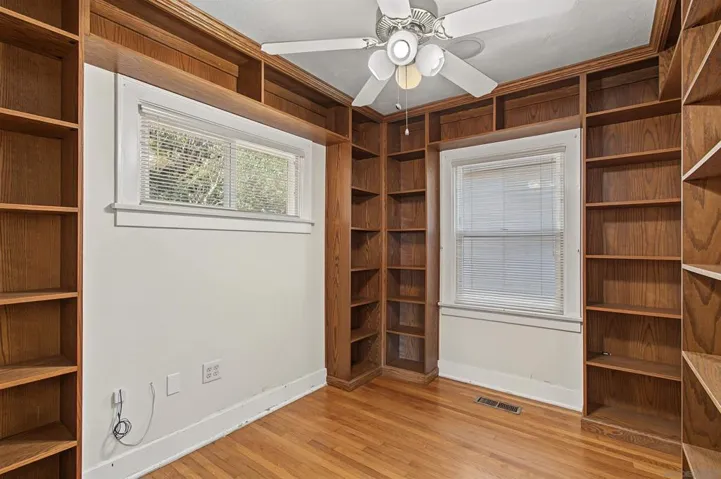 Downstairs bedroom currently set up as den/office with built-in bookshelves