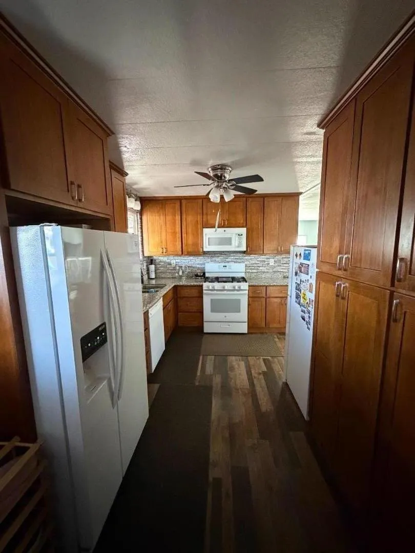 View of the kitchen area from the hallway. View of the kitchen area from the hallway.