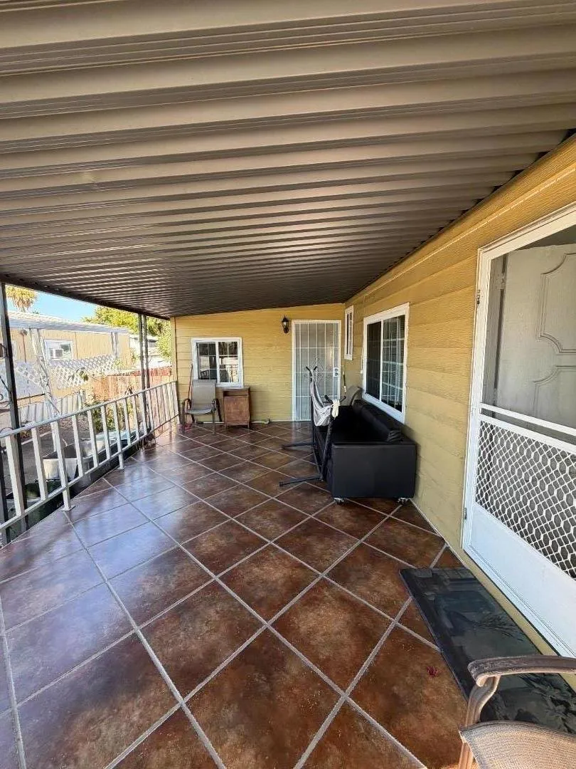 The porch area next to the cabana on the left side of the property. The porch area next to the cabana on the left side of the property.