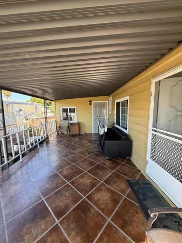 The porch area next to the cabana on the left side of the property.