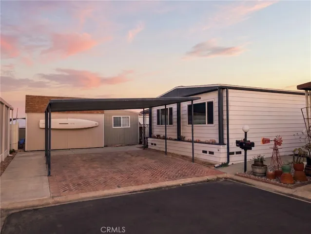 Large carport, AI enhanced by removing the vehicles on the driveway