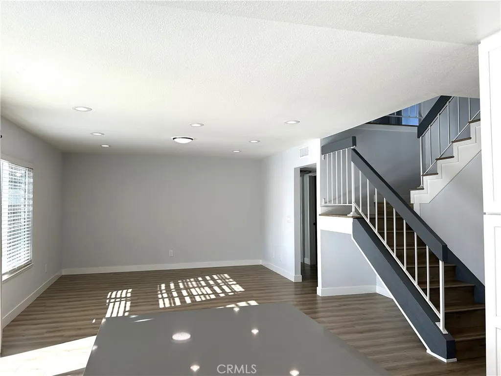 Bright and spacious living area with an open staircase