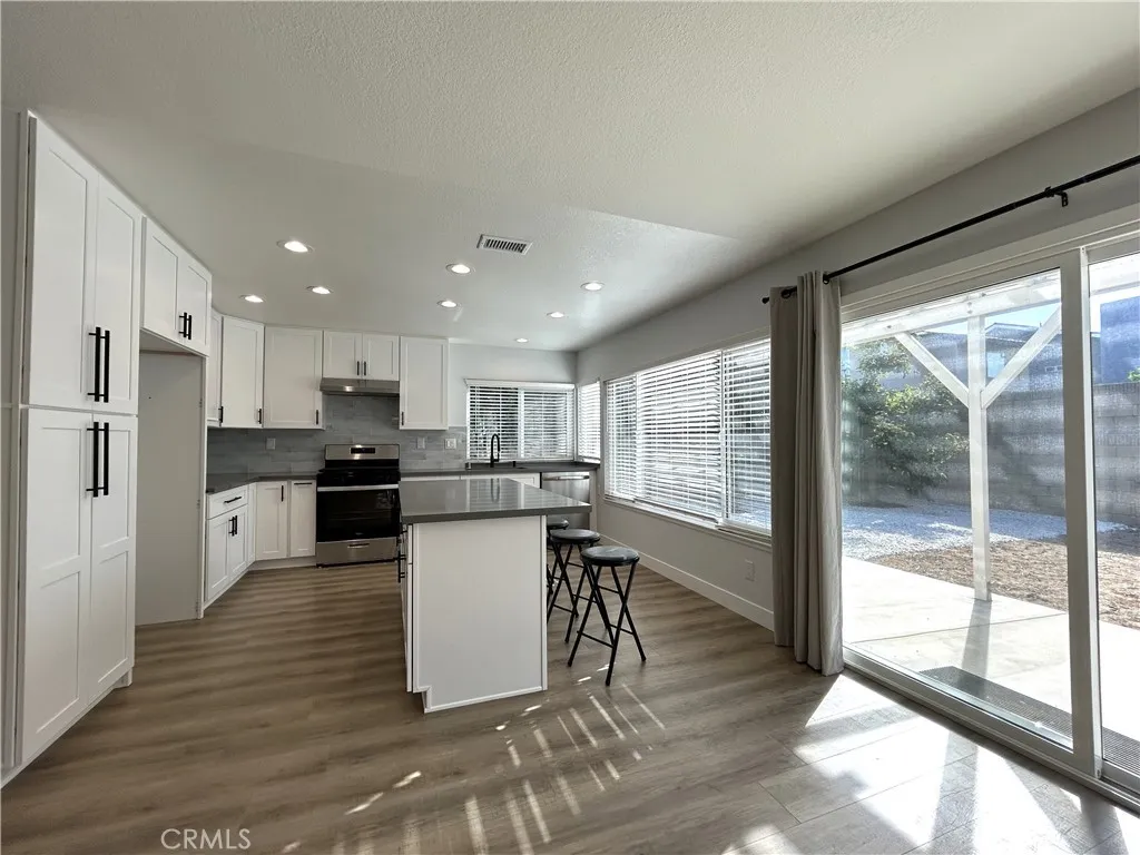 Remodeled kitchen with an island and easy access to the backyard