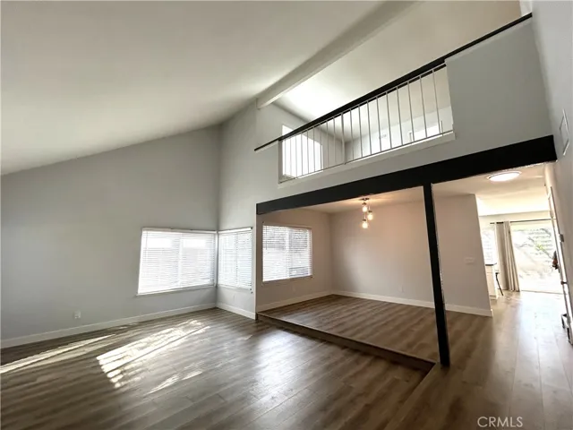 Soaring ceilings and an open loft add to the living room’s spacious feel