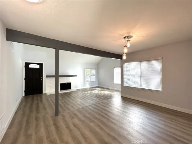 Light-filled living room with a fireplace and adjacent dining area