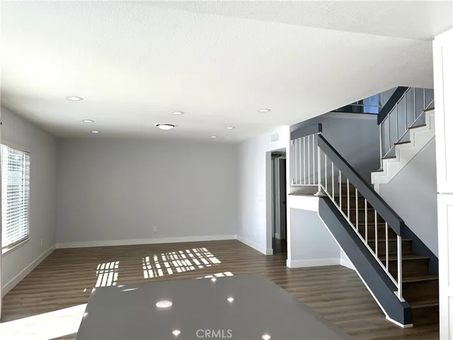 Bright and spacious living area with an open staircase