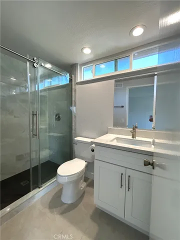 Updated primary bathroom with a glass-enclosed shower