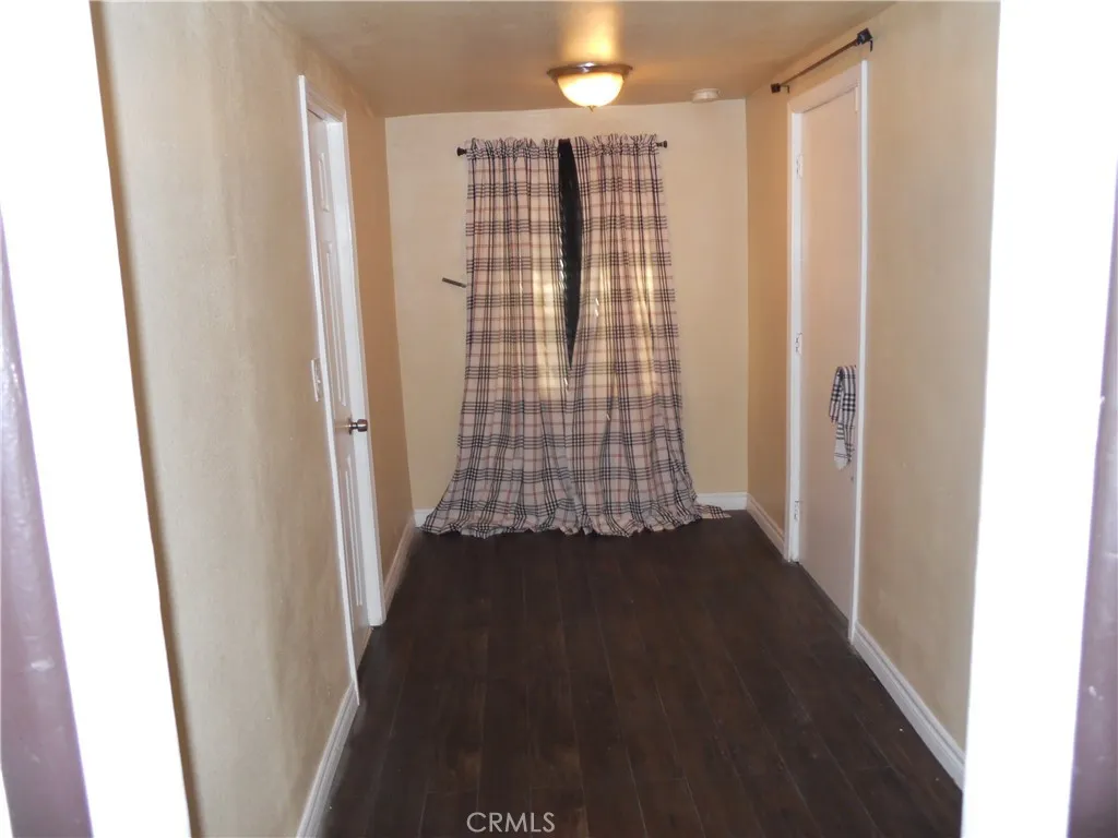 SMALL HALLWAY TO THE SECOND BATH AND THE FOUR ROOM