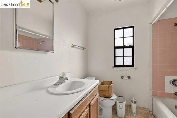 Wood-finish vanity with an integrated sink and countertop