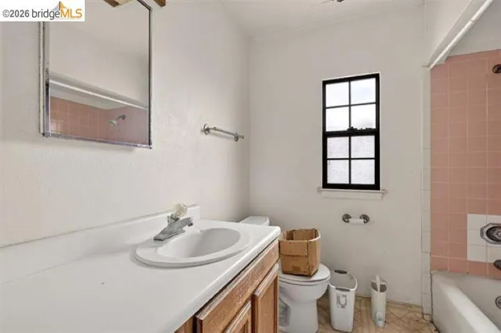 Wood-finish vanity with an integrated sink and countertop