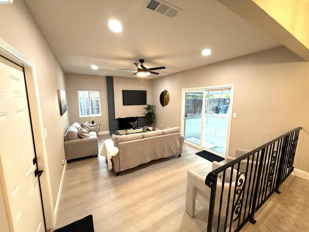 Recessed ceiling lighting, vaulted ceilings, modern ceiling fan, brick-clad fireplace, and sliding glass doors to the exterior Recessed ceiling lighting, vaulted ceilings, modern ceiling fan, brick-clad fireplace, and sliding glass doors to the exterior