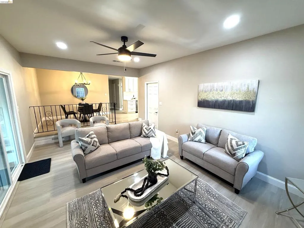 Recessed lighting, ceiling fan, and wood-finish flooring in the living area Recessed lighting, ceiling fan, and wood-finish flooring in the living area