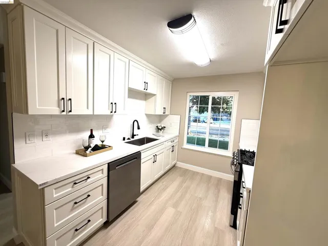 White shaker cabinetry with matte black hardware