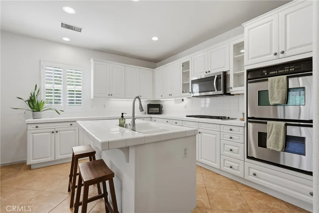 Kitchen with stainless steel appliances including double oven & microwave