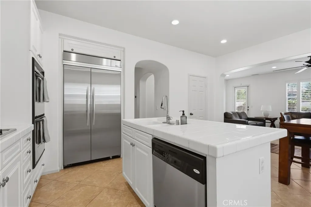 Kitchen with stainless steel appliances including built in refrigerator and dishwasher