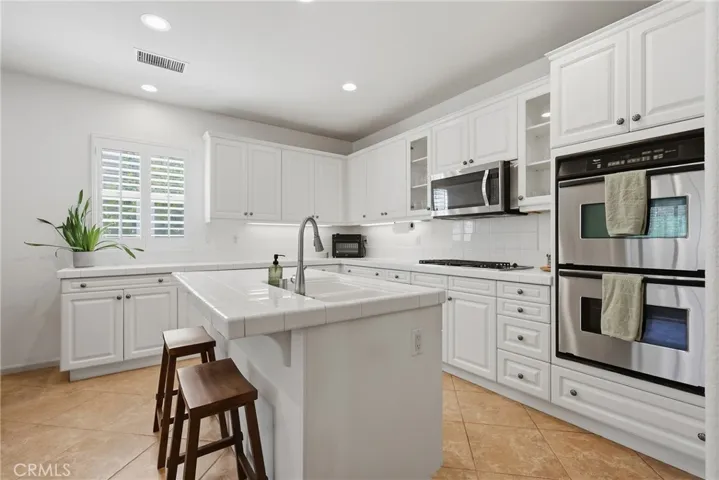Kitchen with stainless steel appliances including double oven & microwave