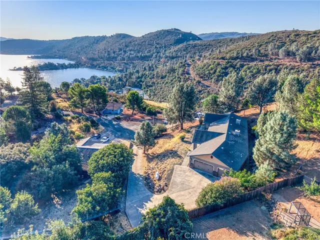 Aerial view of home with lake nearby