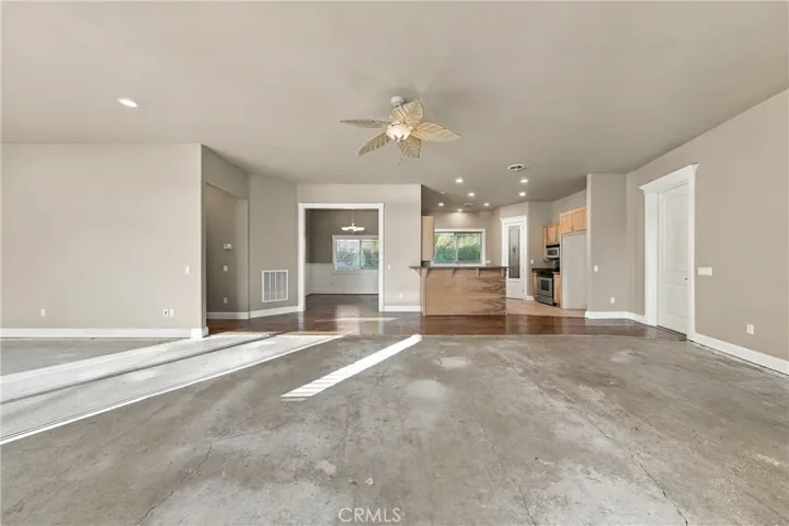 spacious living room , just needs you to add carpet