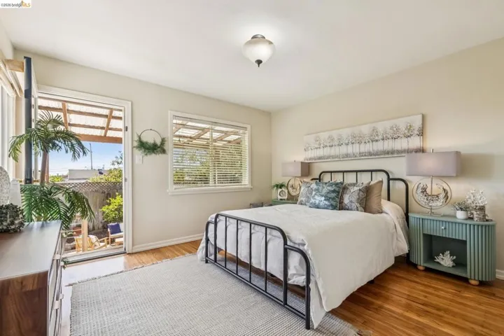 Wood-finish flooring, white walls, and a white ceiling light fixture