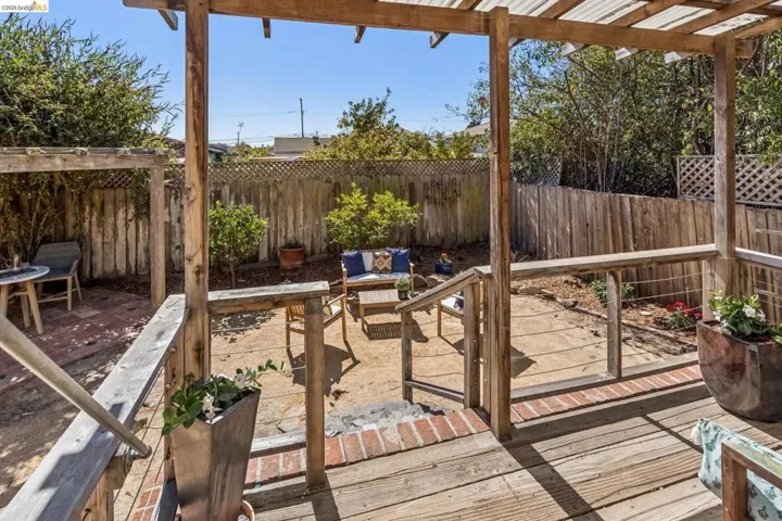 Wood deck with pergola leading to a gravel patio