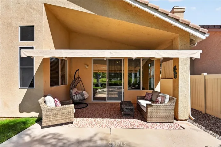Covered patio with electric awning for additional shade