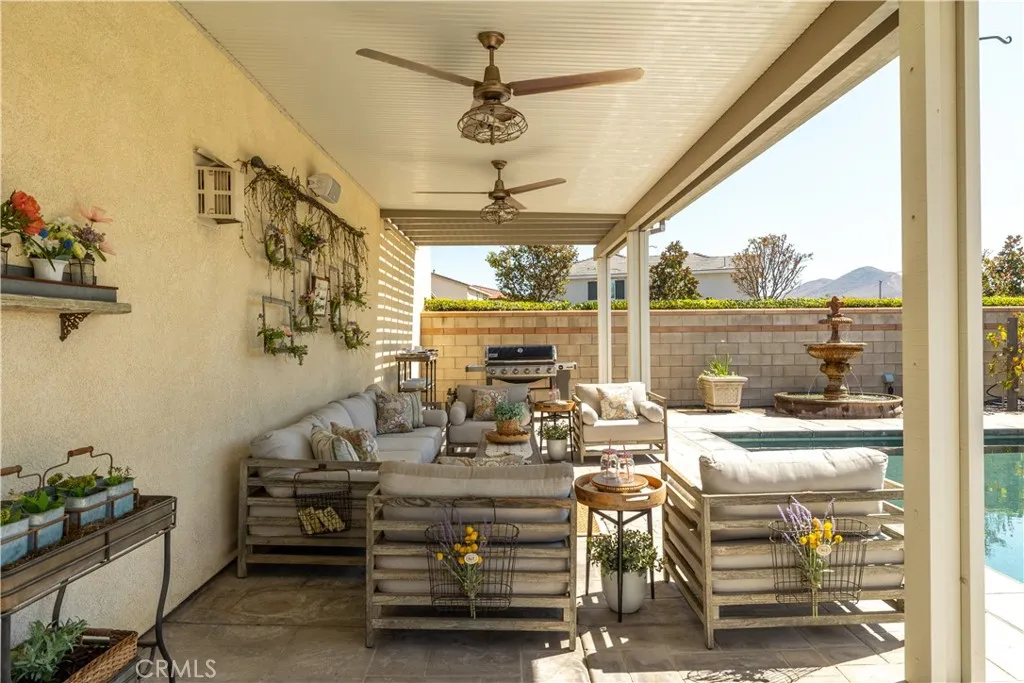 Wrap around patio cover with ceiling fans and block wall for privacy.