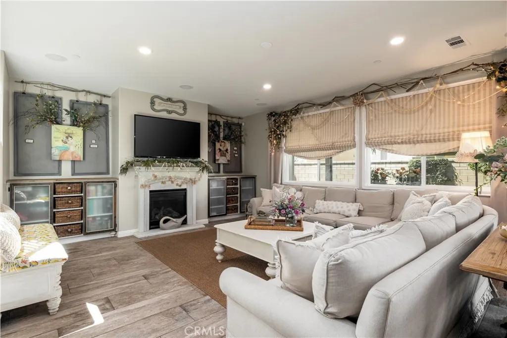 Relaxing living room with fireplace, surround sound and recessed lighting.