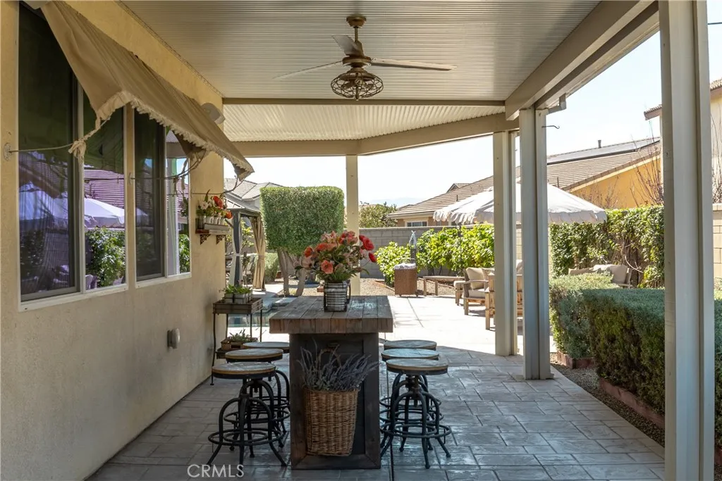 Patio cover with fans and seating area.