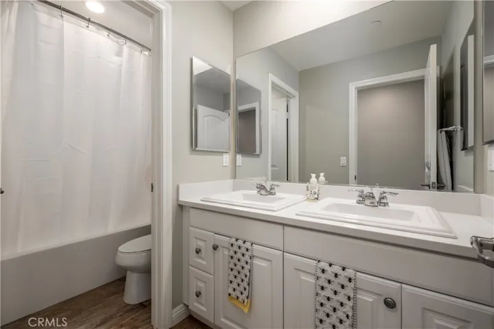 Upstairs secondary bathroom with double sinks.