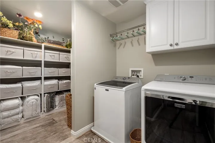 Upstairs laundry room with storage space.
