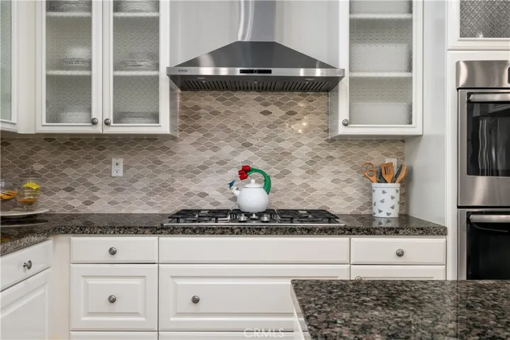 Beautiful white cabinets and designer backsplash.
