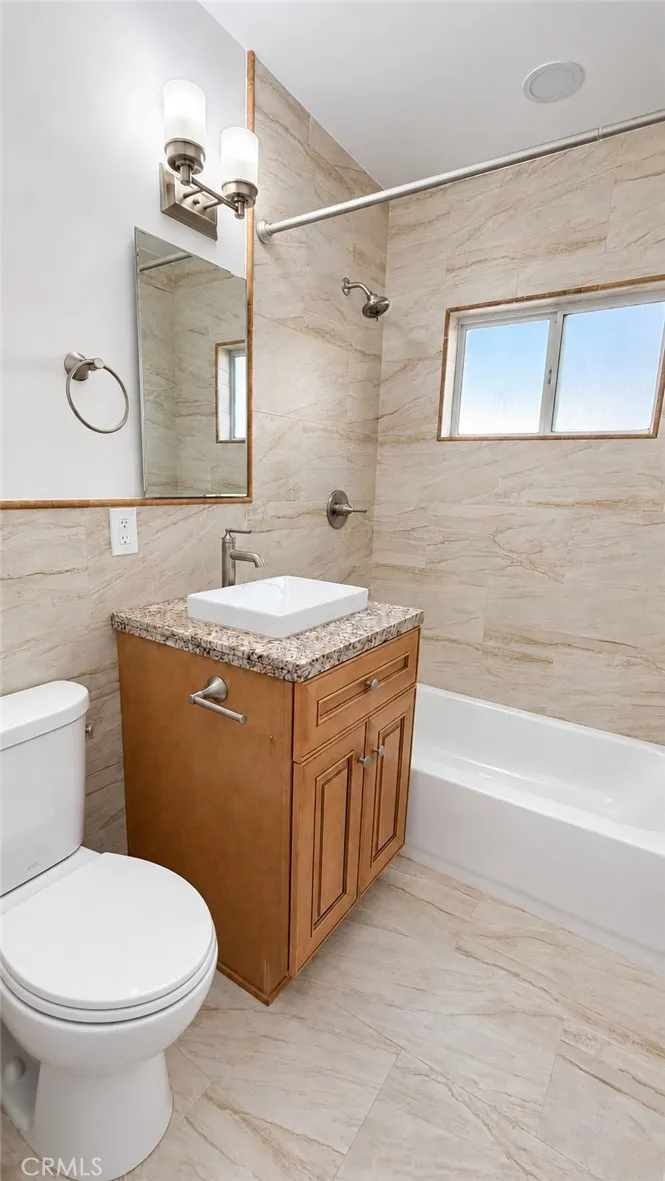 Remodeled full bathroom with granite counter top