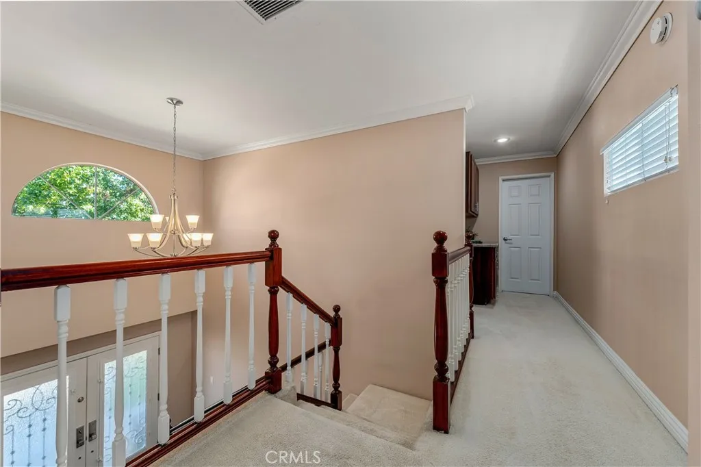 This photo is outside of the primary upstairs bedroom, looking down the hall, which could be a second bathroom upstairs!